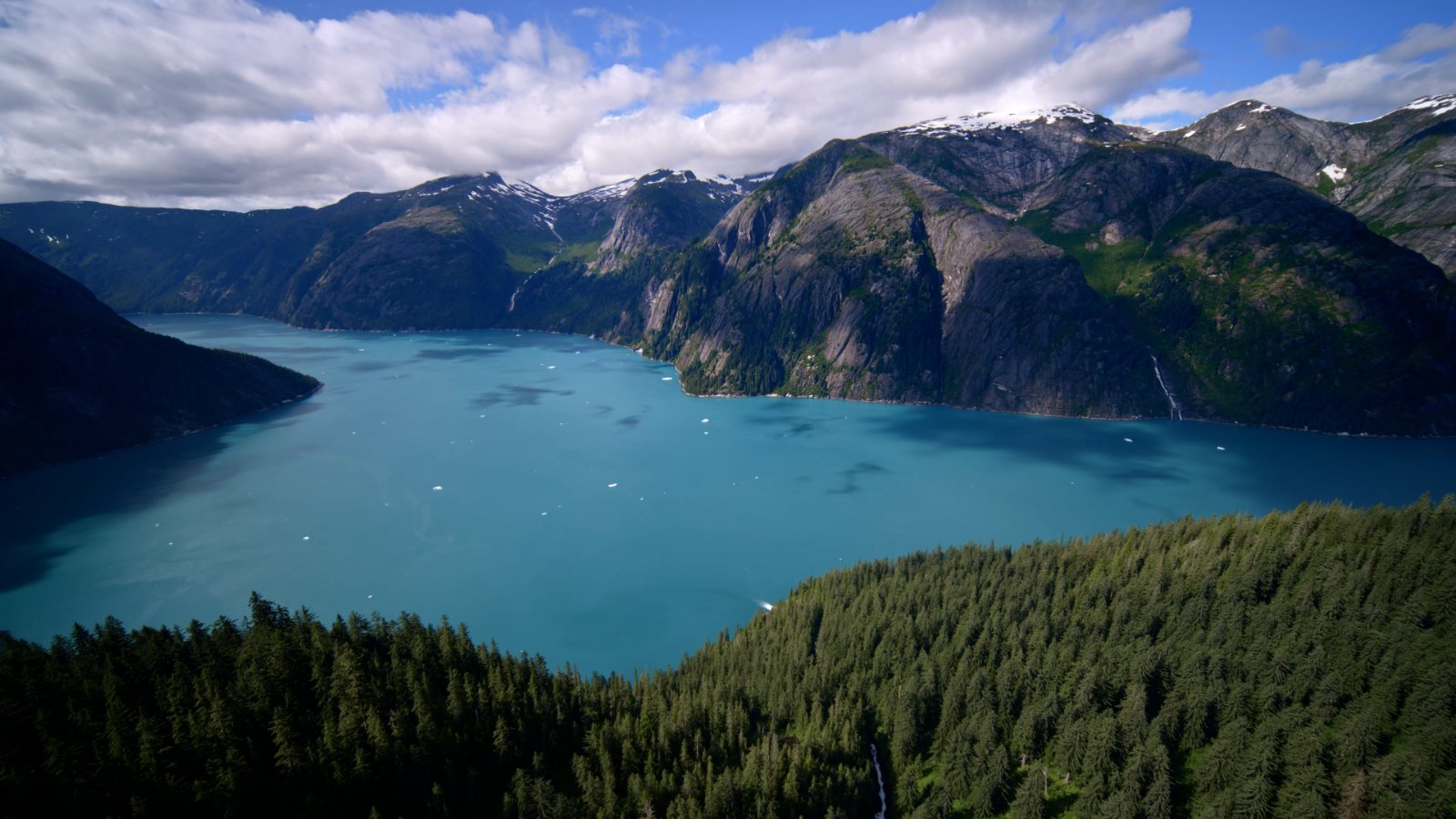 Alpine lake and waterfall in a glacial valley